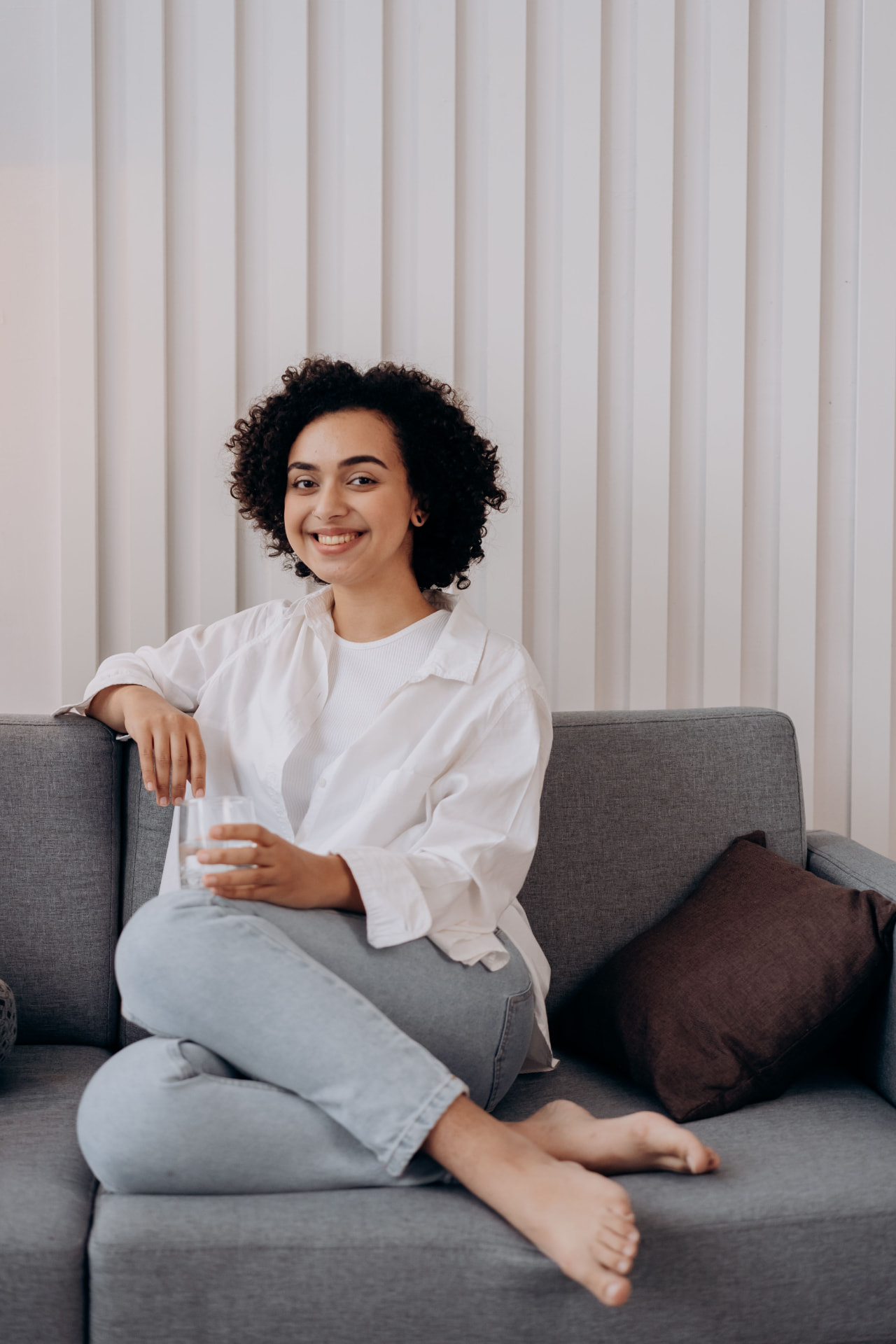 Woman relaxing on a couch, smiling